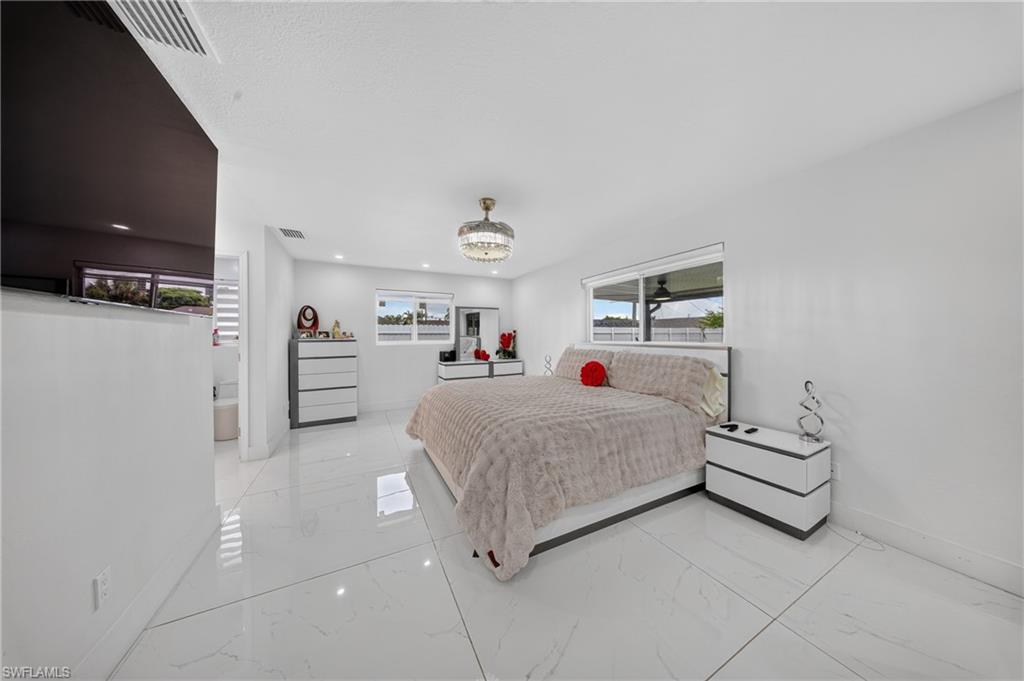 White tile flooring, recessed lighting, ceiling-mounted lighting fixture, and multiple windows