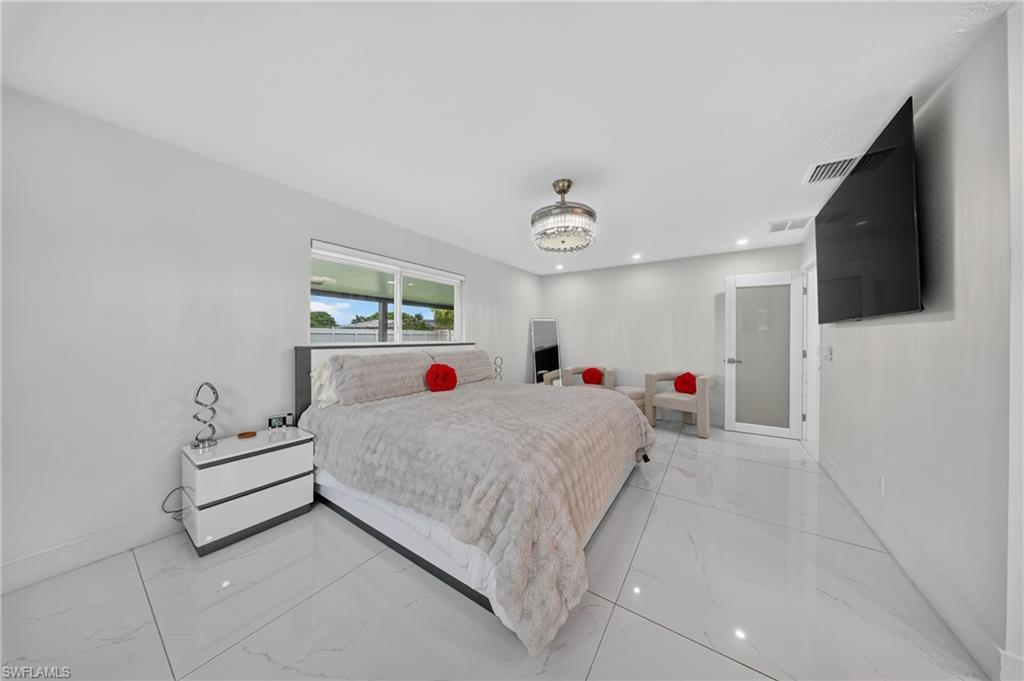 White large-format tile flooring, recessed lighting, and a contemporary ceiling fixture
