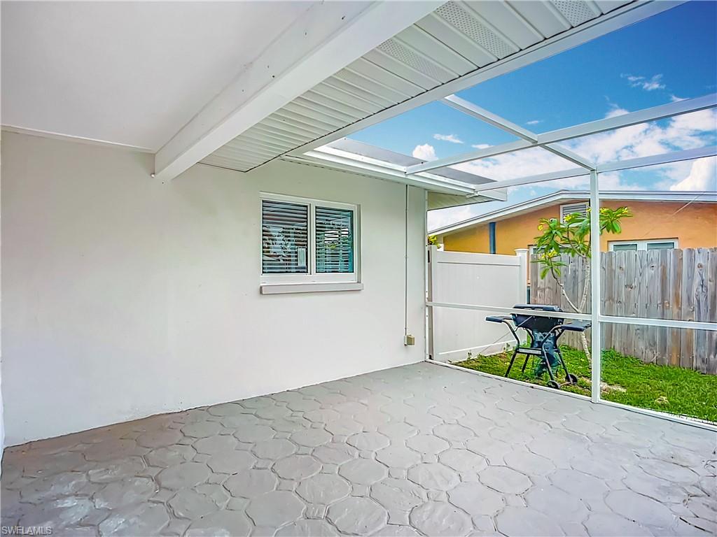 Covered patio with stamped concrete flooring and a screened enclosure