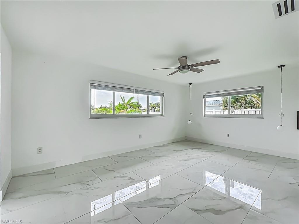 White-painted walls and a ceiling fan with integrated lighting