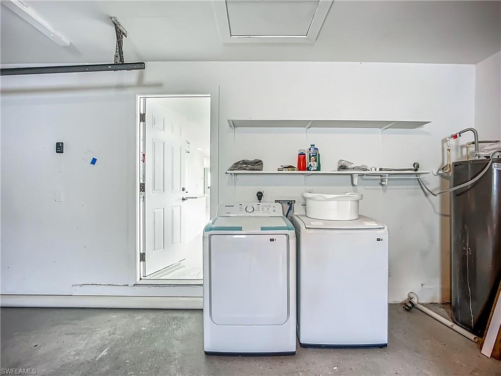 Interior garage with concrete flooring, overhead fluorescent lighting, and built-in shelving
