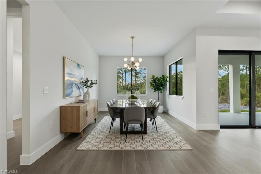 Wood-finish flooring, recessed lighting, and a contemporary chandelier