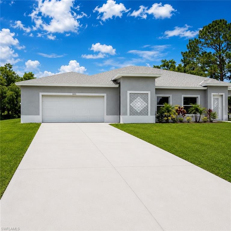 Contemporary stucco exterior with a gray and white color palette, an attached garage, a full-length paved driveway, and mature landscaping