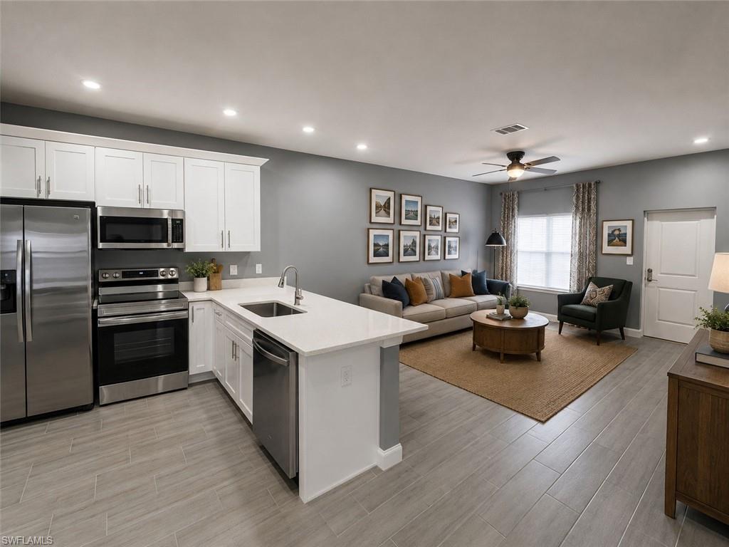 Open-concept living area with plank-style flooring