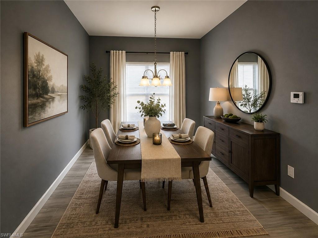 Recessed dining area with a three-light chandelier, a window featuring blinds and curtains, and wood-finish flooring