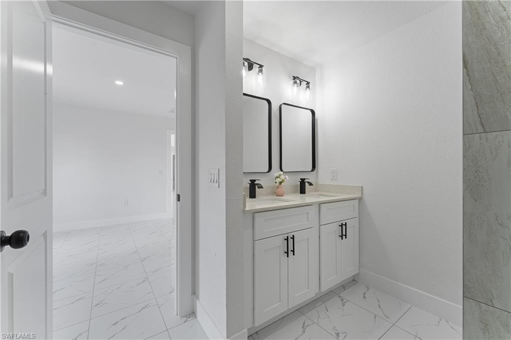 Dual vanity with white shaker cabinets, matte black hardware, and rectangular mirrors