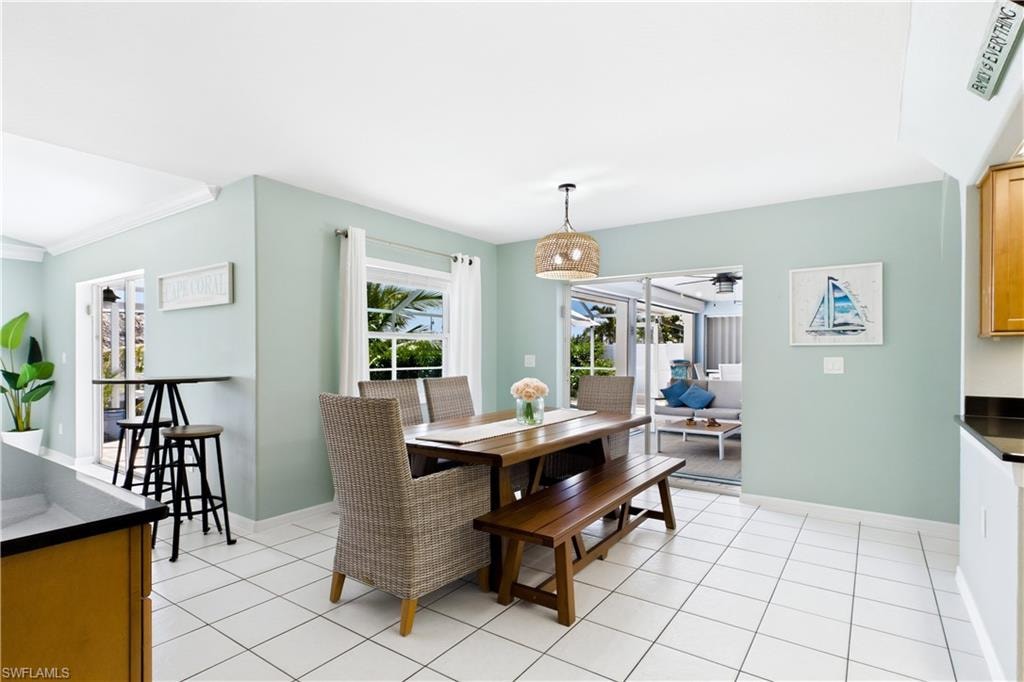Dining area with sliding glass doors leading to the outdoor living area.