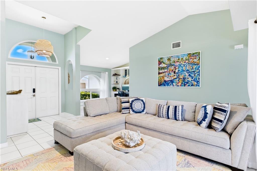 Living Room opens to flex space with built in cabinets and shelves.