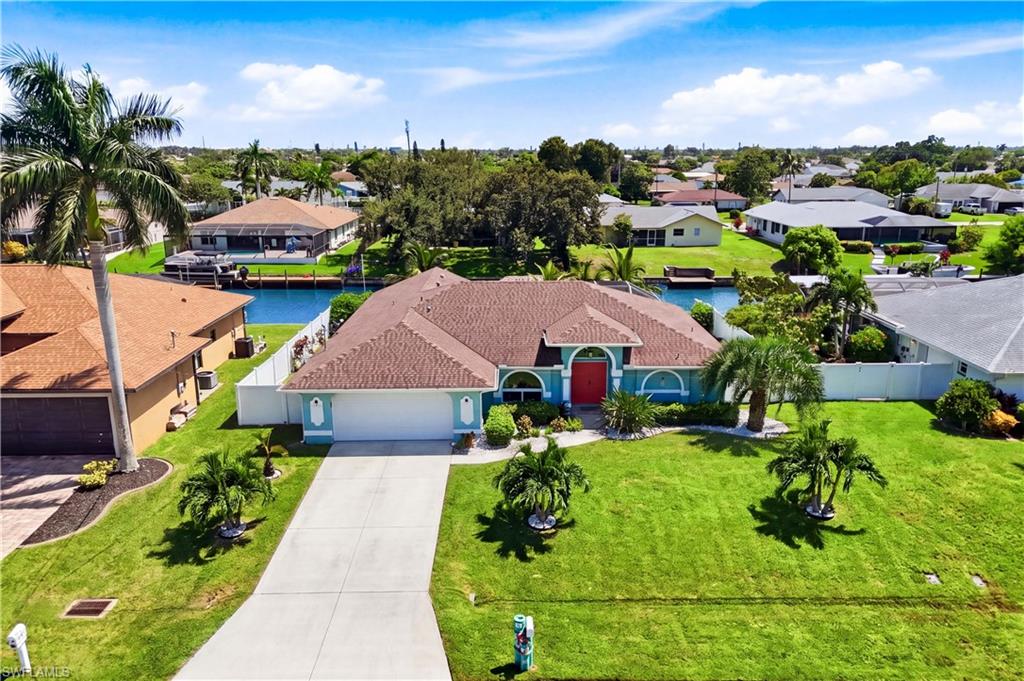 Canal home, vibrant exterior, and fenced in backyard