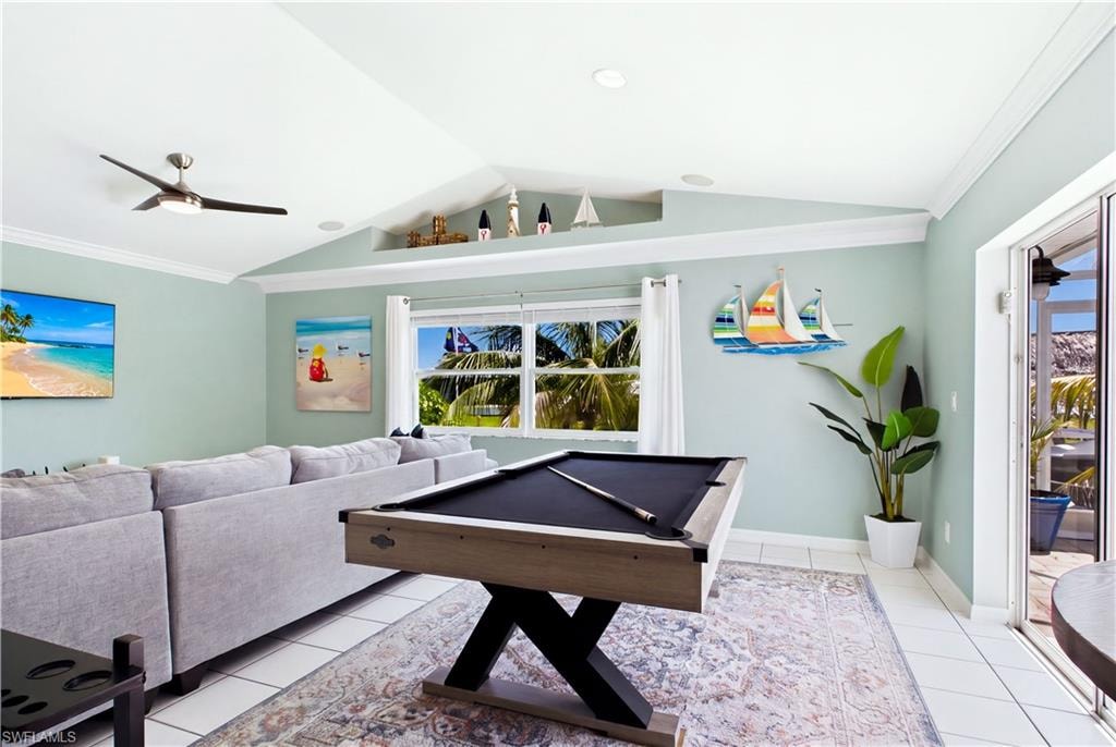 Vaulted ceiling featuring a ceiling fan, recessed lighting, and a decorative ledge.