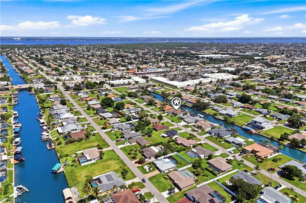 Aerial perspective of a residential neighborhood featuring canals and proximity to Midpoint Bridge.