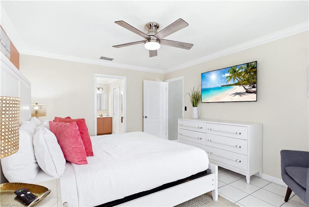Crown molding accents and a large spacious bright master bedroom.