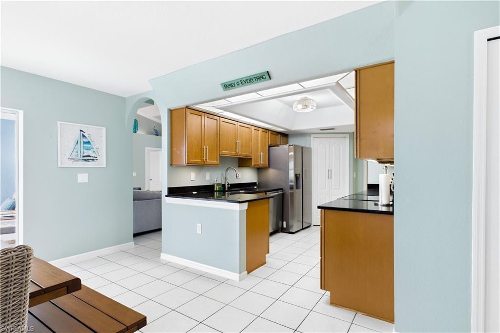 Kitchen featuring dark countertops, a stainless-steel appliances.