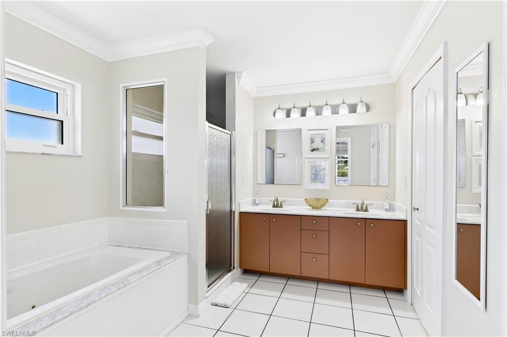 Built-in bathtub and glass-enclosed shower.