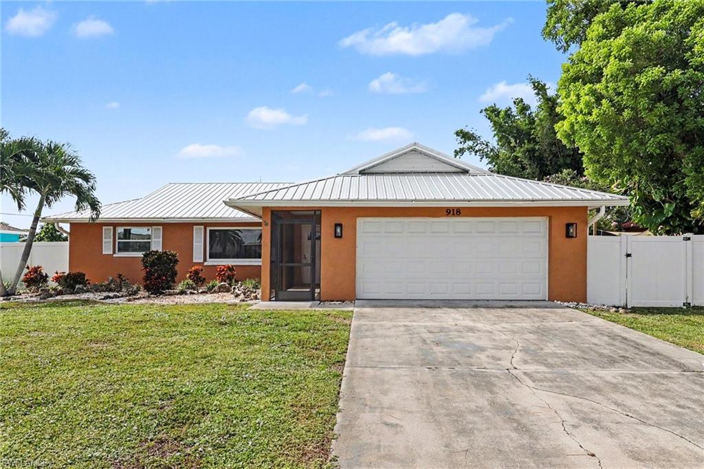 Orange stucco exterior with a white metal roof