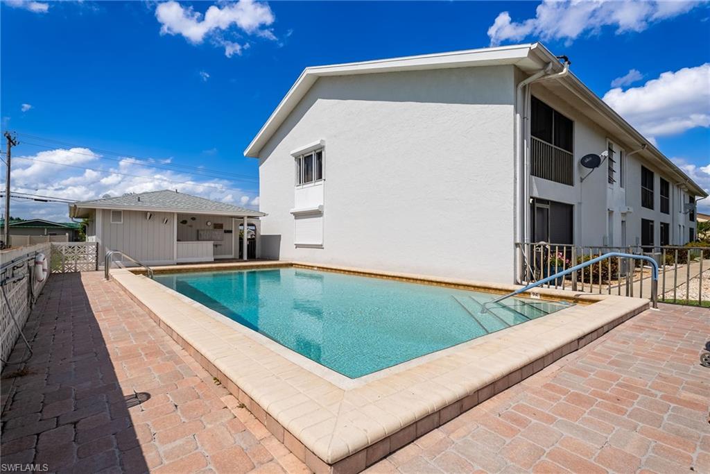 Rectangular swimming pool with integrated steps, surrounded by brick paver decking
