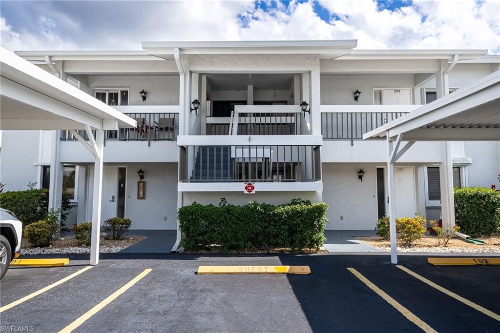 Two-story residential building with private balconies and exterior staircases