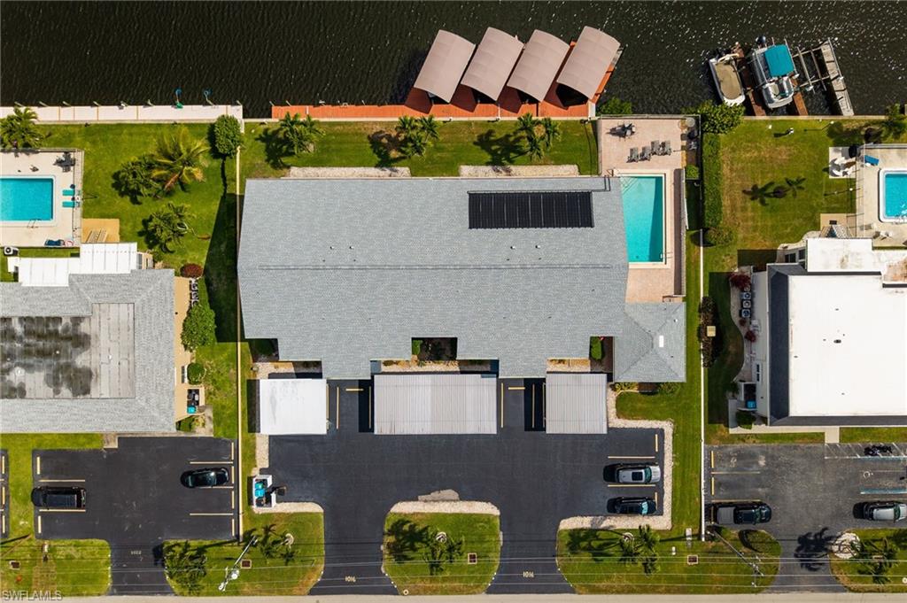 Waterfront property with boat slips, private swimming pool, and dedicated parking