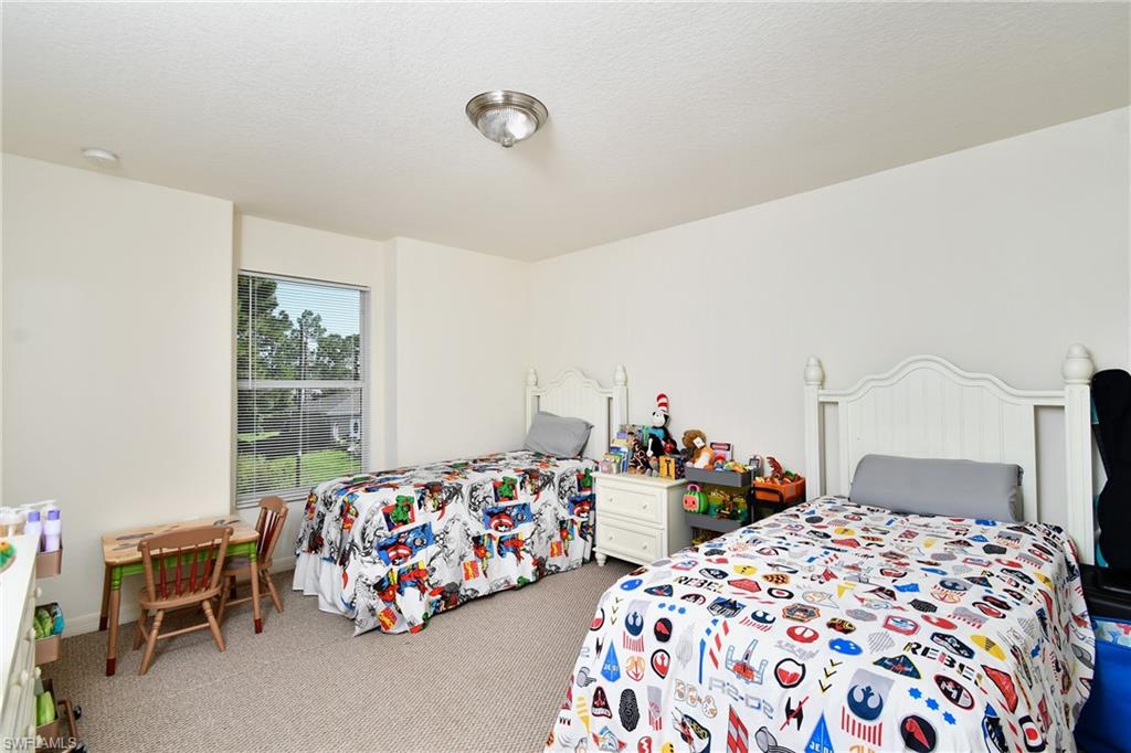 Recessed lighting, large window, and wall-to-wall carpeting