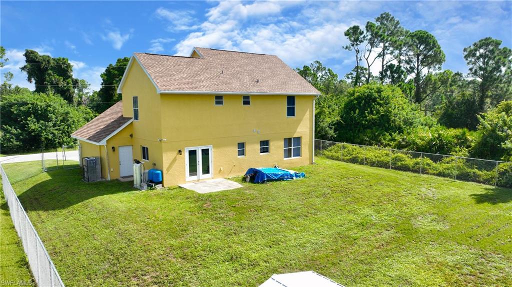 Expansive rear yard with a perimeter fence, offering a private outdoor area