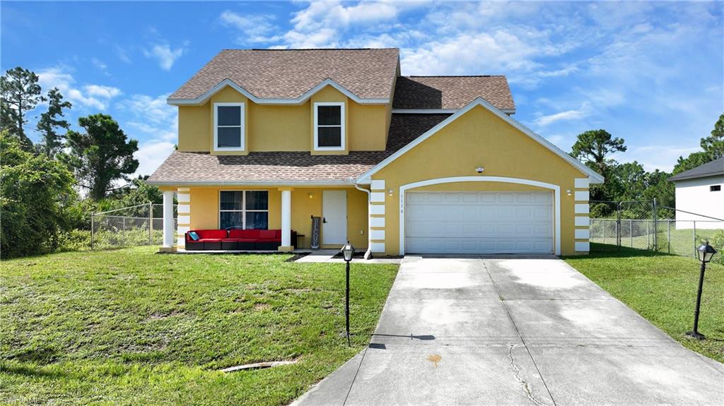 Two-story residence with a pitched shingle roof, attached two-car garage, covered entry, and dormer windows