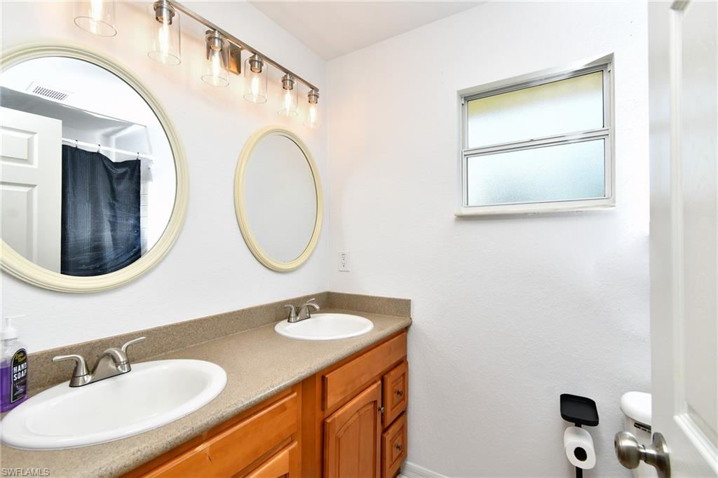 Dual vanity with integrated sinks and brushed nickel faucets