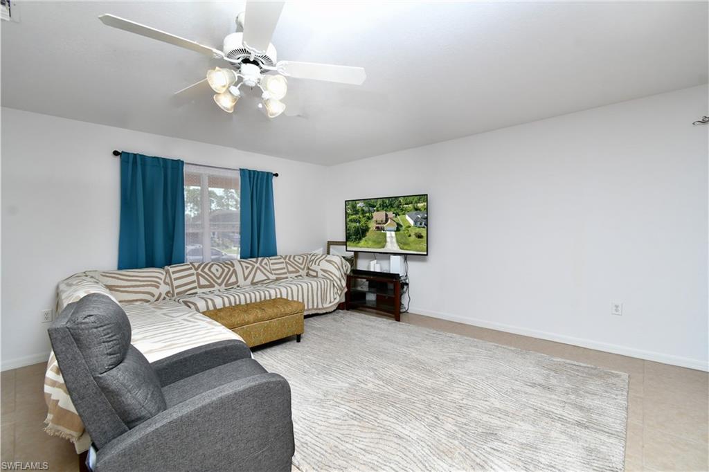White painted walls with a window featuring a dark curtain rod