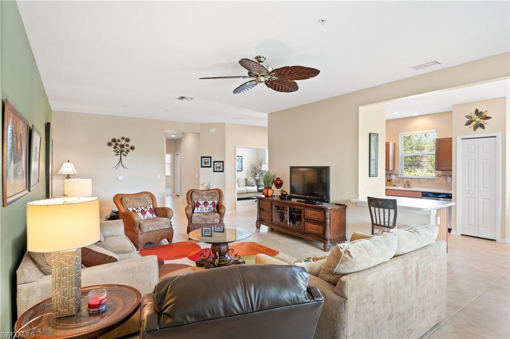 Expansive common area featuring tiled flooring and a ceiling fan