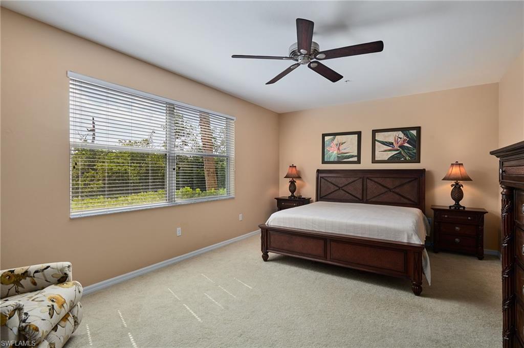 Wall-to-wall carpeting with a ceiling fan featuring dark wood-finish blades