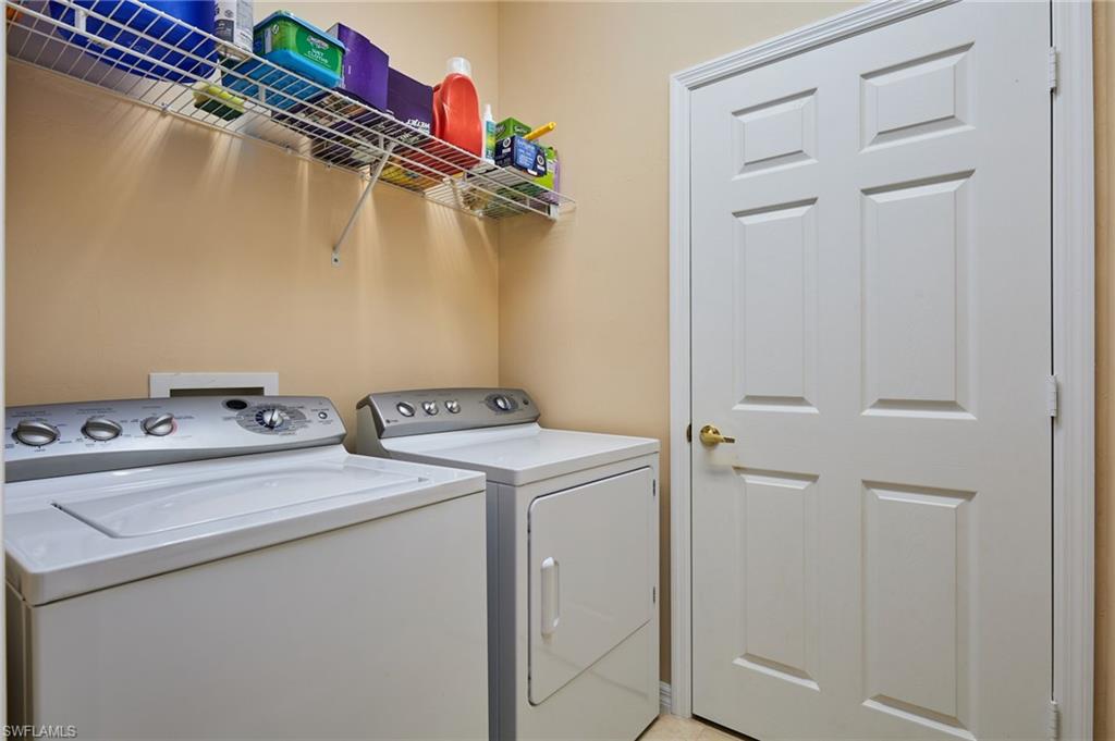 Laundry area featuring a wire storage shelf, a full-size washer, and a full-size dryer