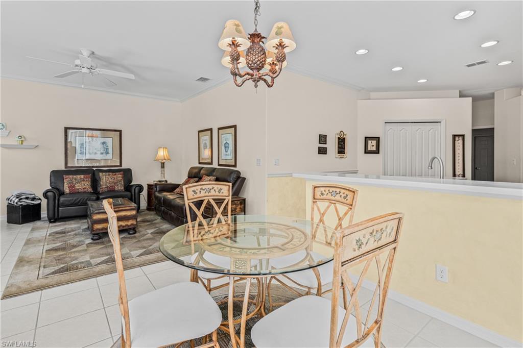 Vaulted ceilings with recessed lighting, white tile flooring, and a ceiling fan