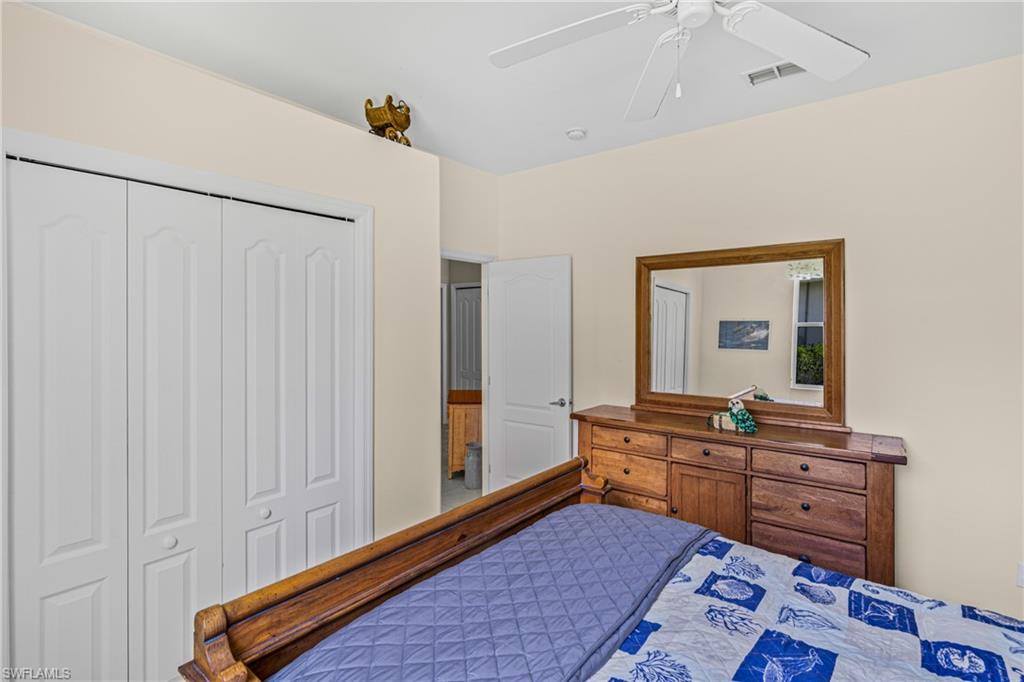 Ceiling fan, white bi-fold closet doors, light-toned wall paint, and interior doorway