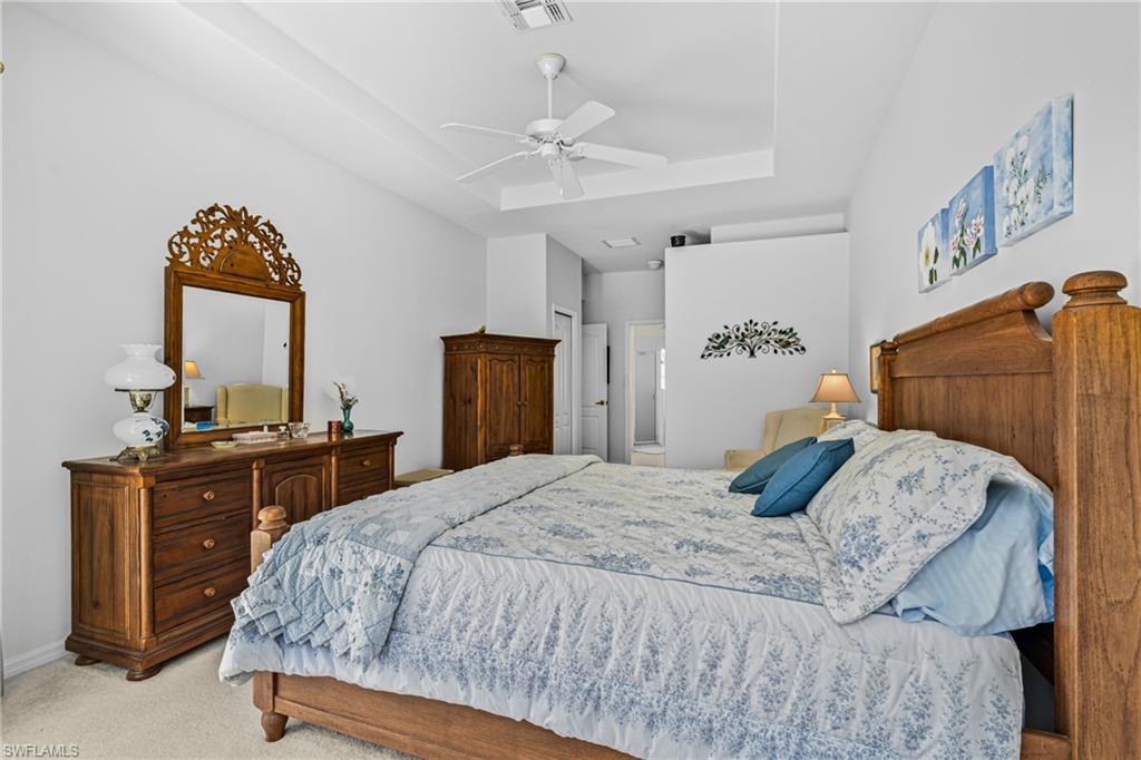 Recessed tray ceiling, ceiling fan, and carpeted flooring