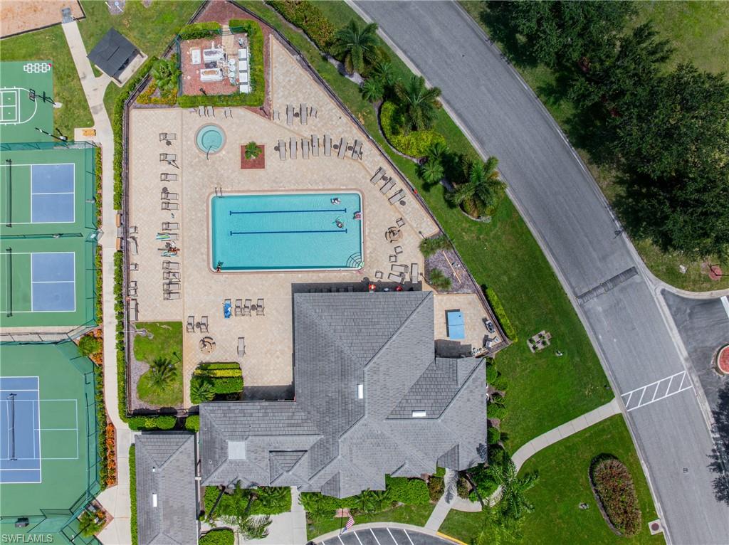 Community pool with dedicated lap lanes, adjacent hot tub, and surrounding lounge area
