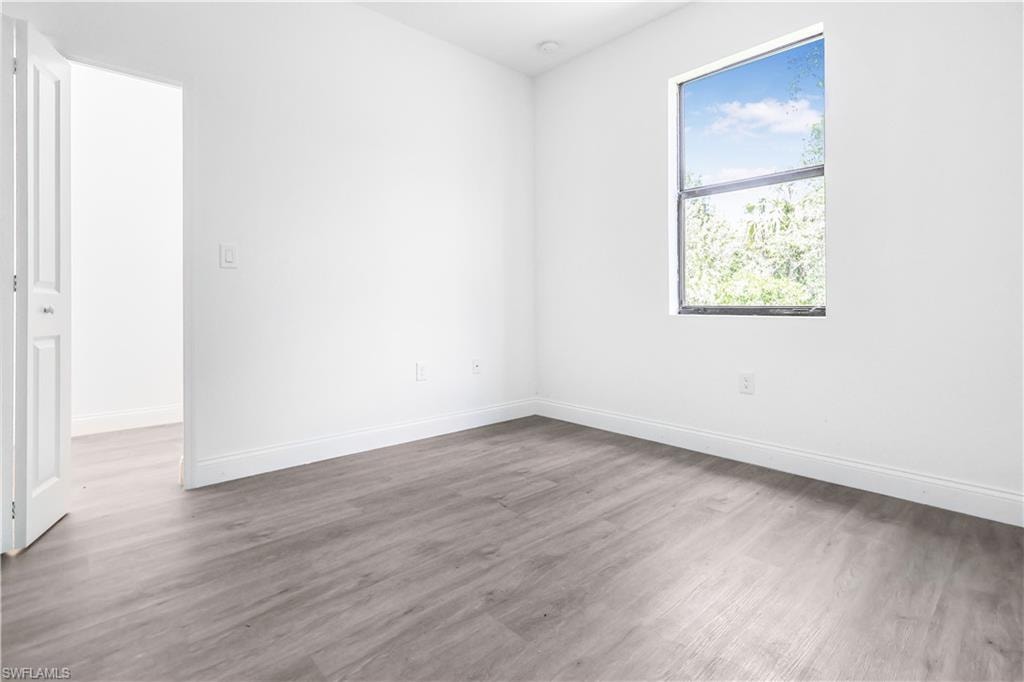 Empty room with wood finished floors and baseboards