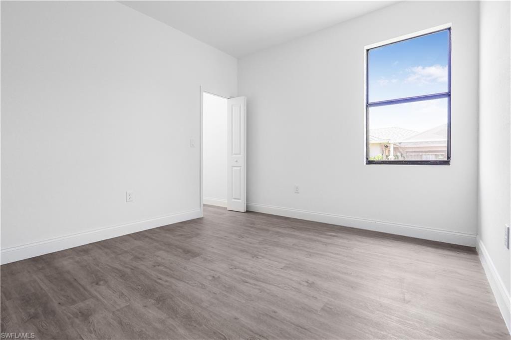 Empty room featuring wood finished floors and baseboards