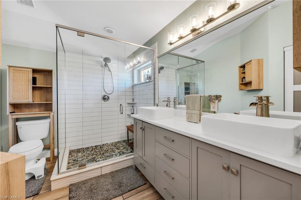 Remodeled primary bath with glass shower