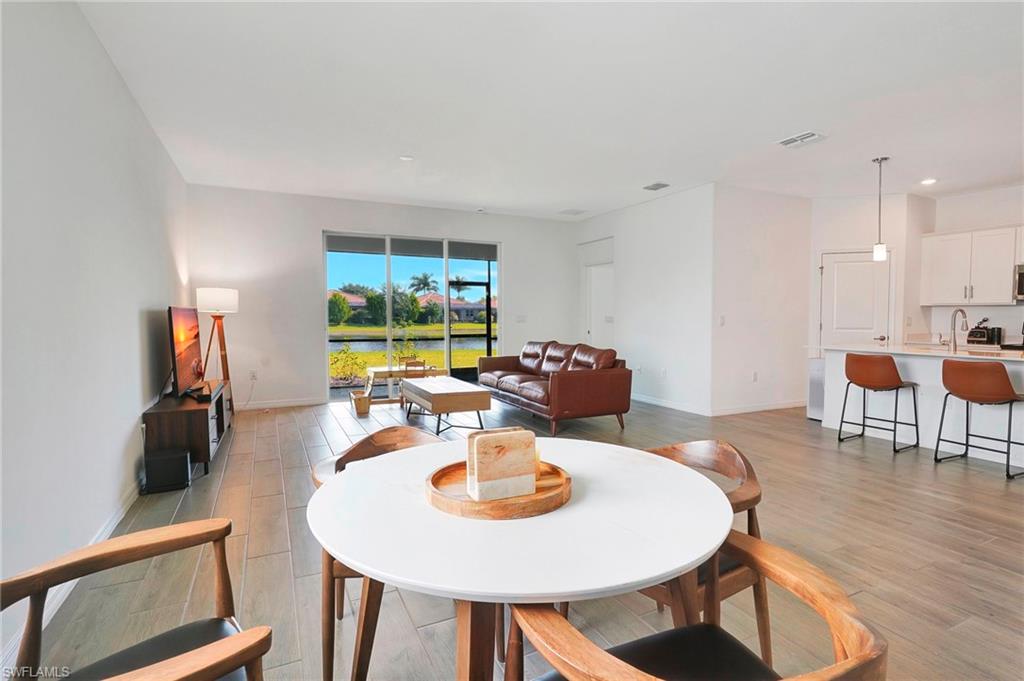 Dining area with sink and light hardwood / wood-style flooring