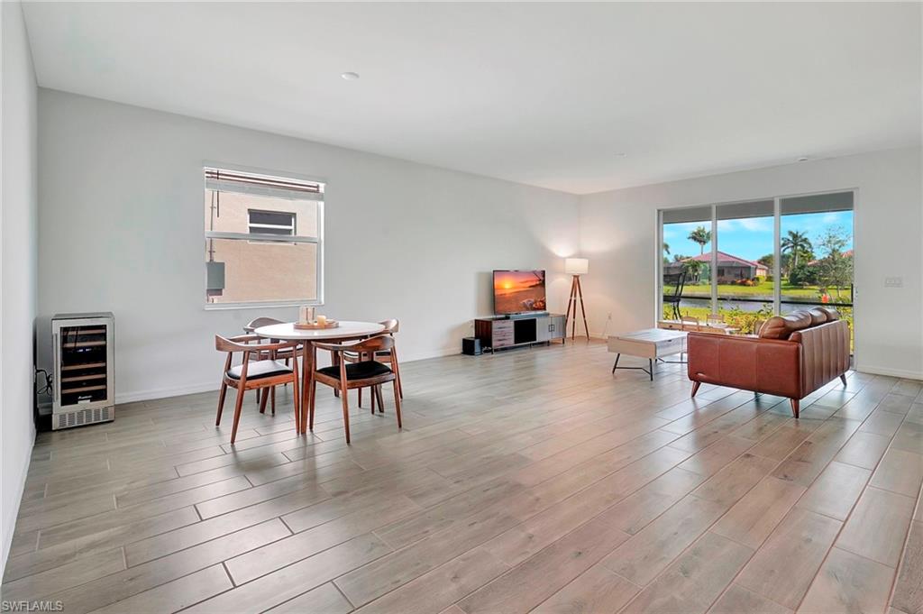 Dining area with light hardwood / wood-style flooring and beverage cooler