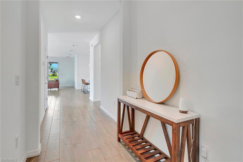 Hall with light hardwood / wood-style floors