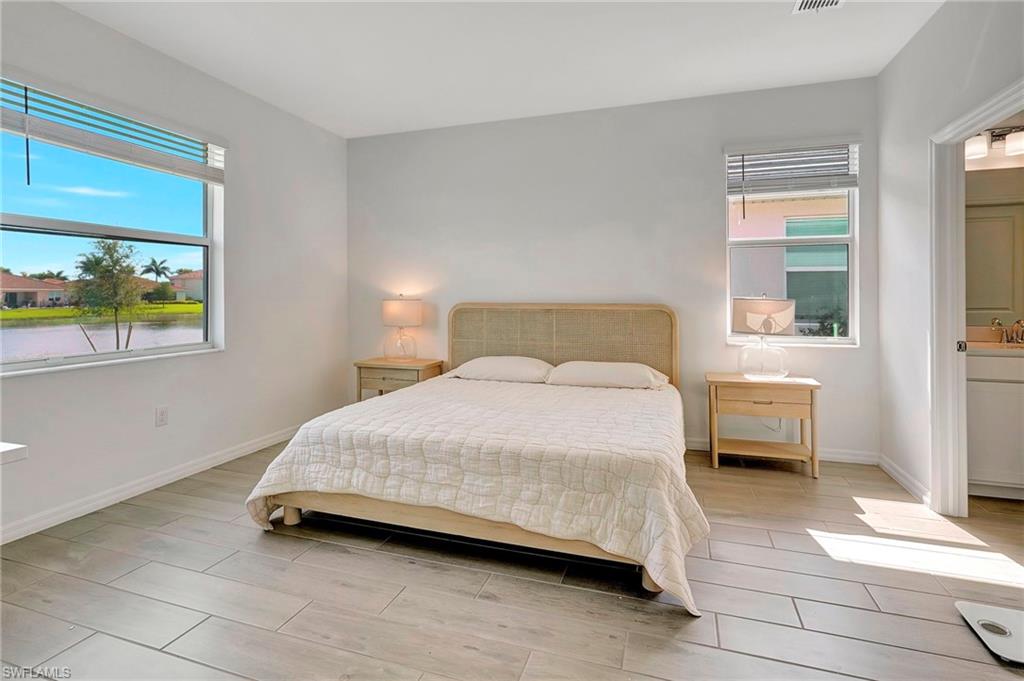 Bedroom featuring multiple windows and ensuite bath