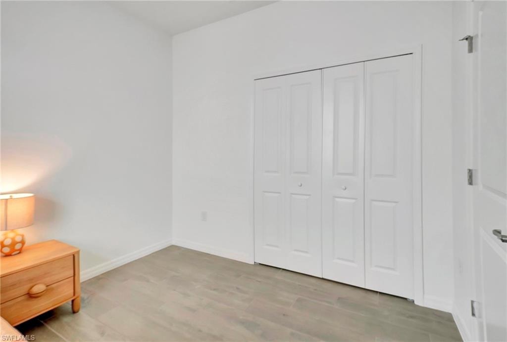 Unfurnished bedroom featuring a closet and light hardwood / wood-style flooring