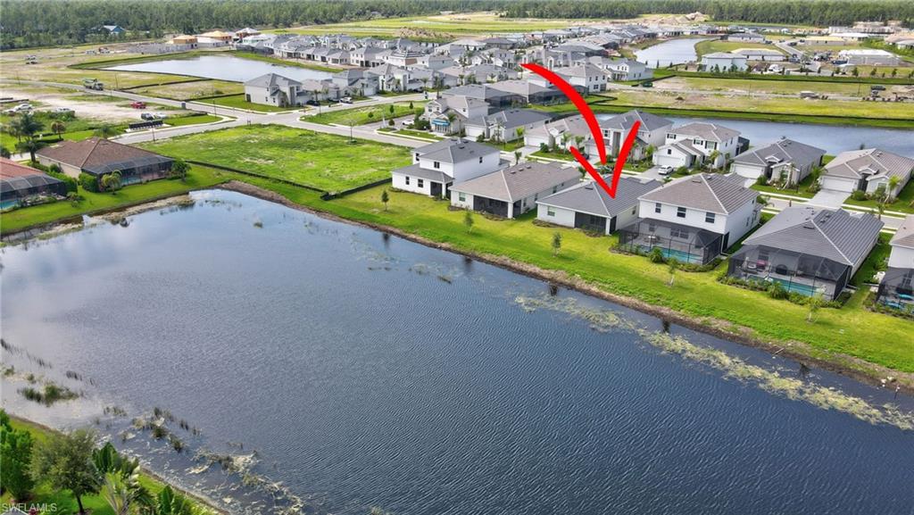 Birds eye view of property featuring a water view