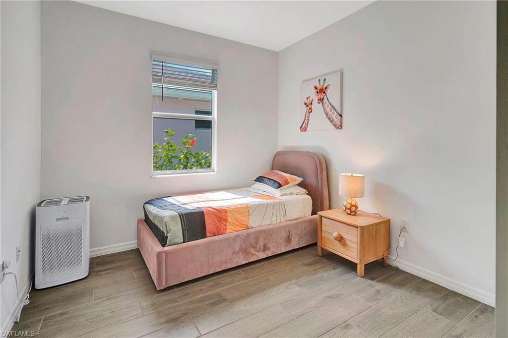 Bedroom with light hardwood / wood-style floors