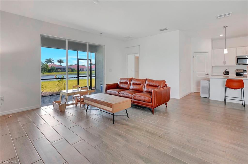 Living room with light hardwood / wood-style floors