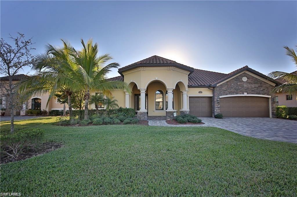 Mediterranean / spanish-style house featuring a yard and a garage