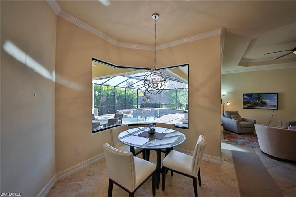 Dining room featuring ceiling fan and ornamental molding