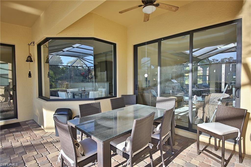 View of patio featuring ceiling fan and glass enclosure