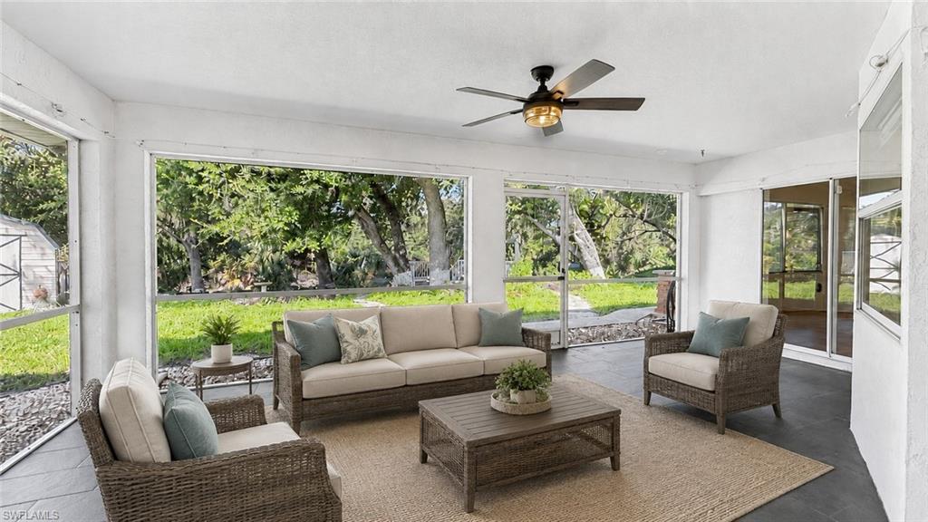 Virtually staged with sun room furniture. Expansive backyard views