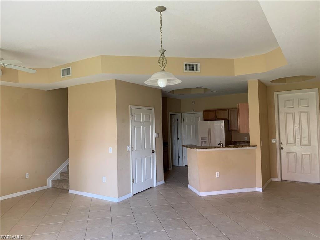 Front door entry to the right.  Kitchen w/ pantry door closed and staircase to 2nd floor on left